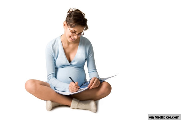 Pregnant woman takes notes