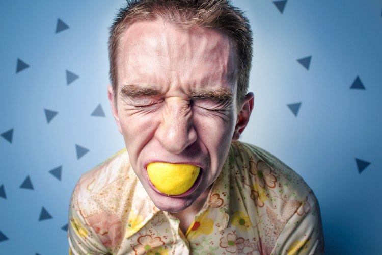Man eating lemon